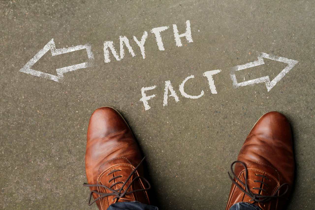 Man standing in front of two arrows and the words Myth and Fact